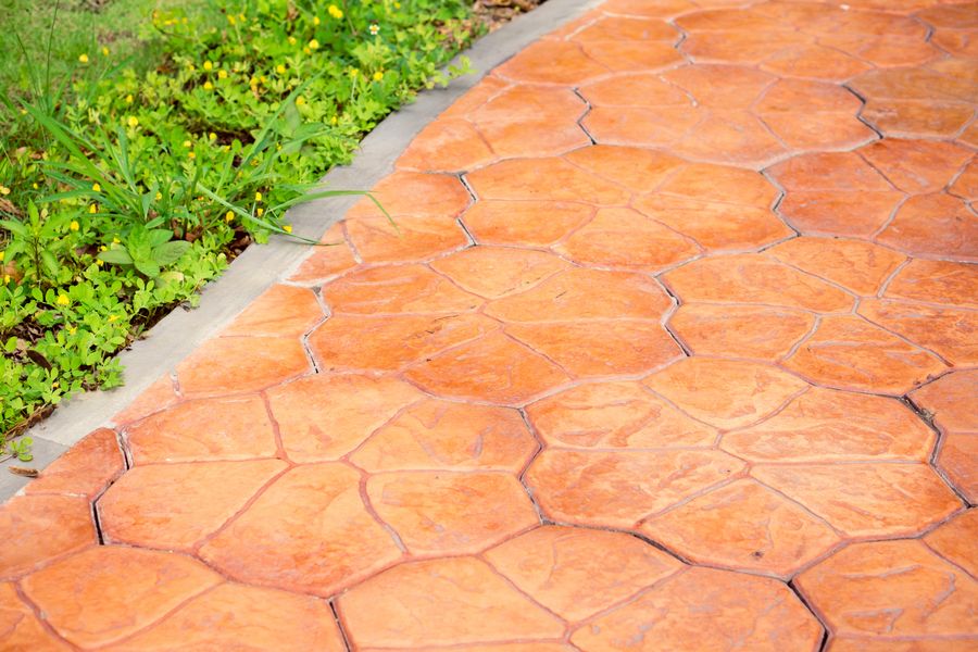 Orange stamped concrete footpath with blue edging
